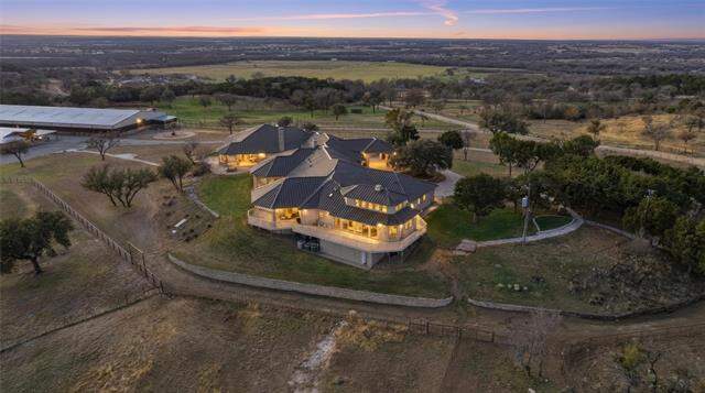 Aerial sunset view of the hilltop estate and acreage at 128 Countdown Trail